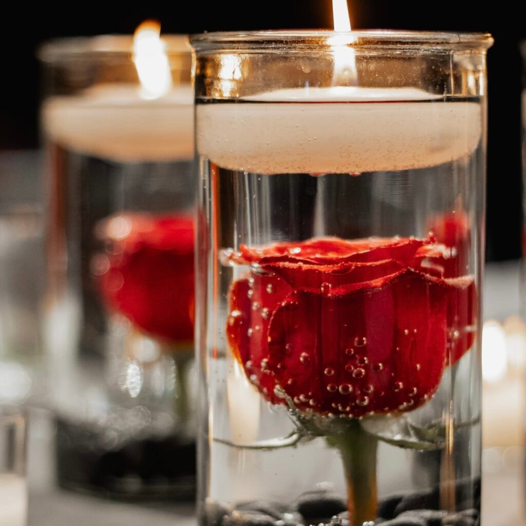 Floating candle paired with a single red rose
