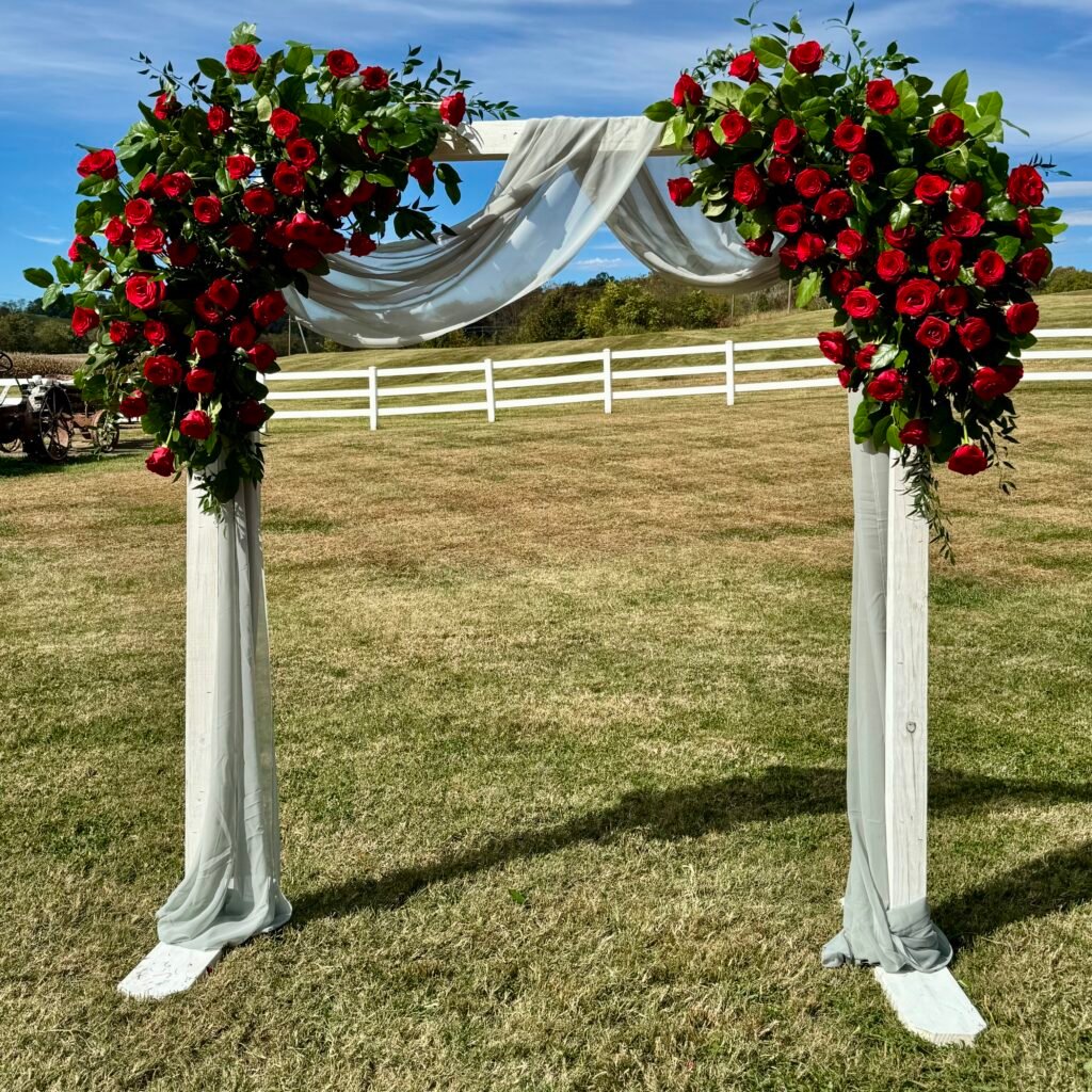 Red rose floral arch installation for a wedding